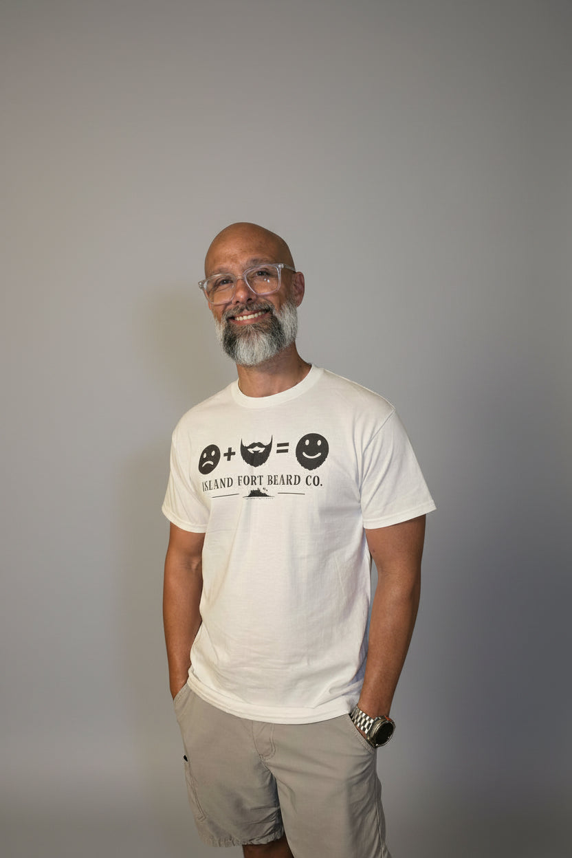Man wearing a white t-shirt with a logo and text, standing against a plain background
